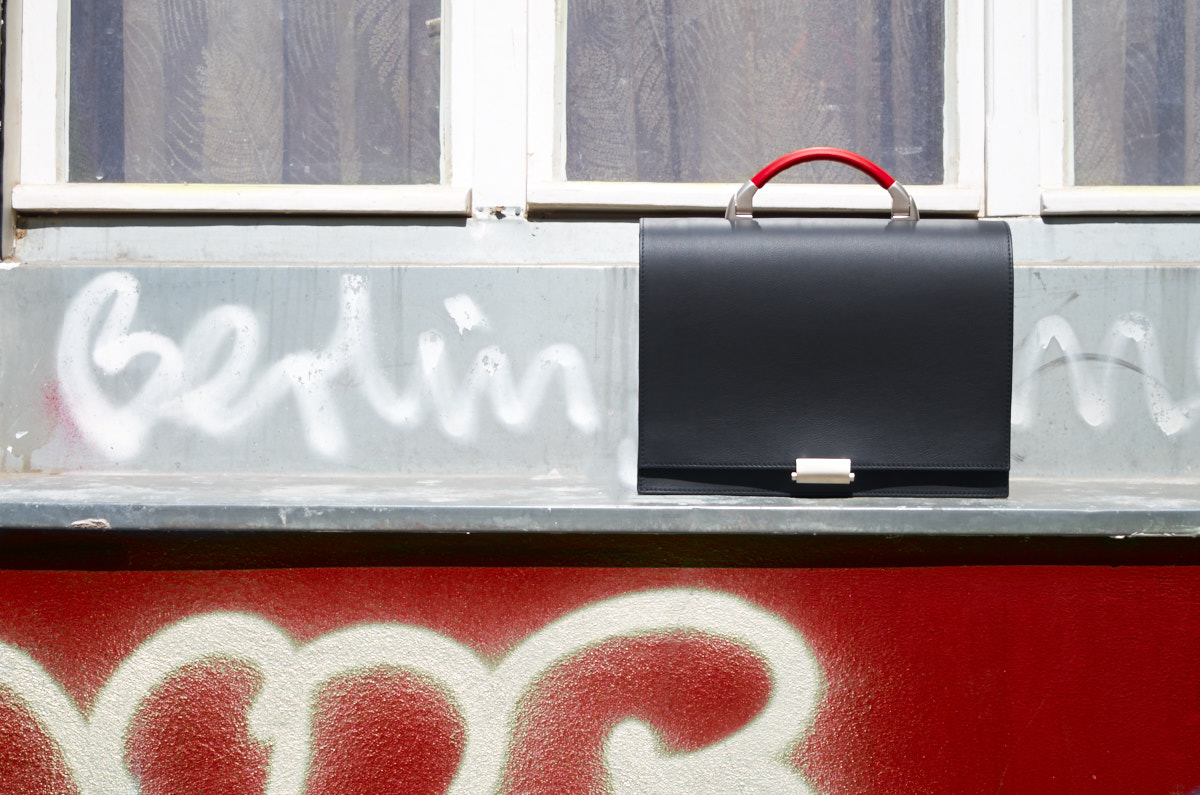 Olbrish businessbag Kant sitting on a windowsill next to a spraypainted tag that reads Berlin
